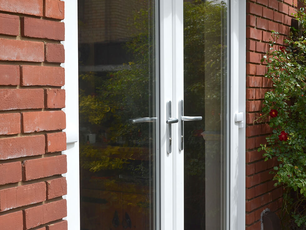 White uPVC french door with silver hardware